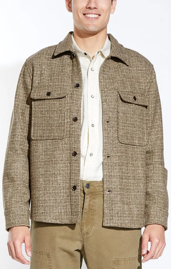 Model wearing a textured tweed shirt jacket over a cream button-up shirt