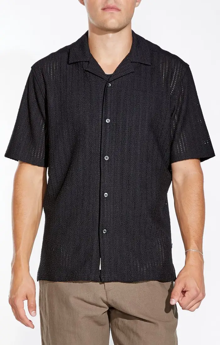 Model wearing a black textured camp shirt