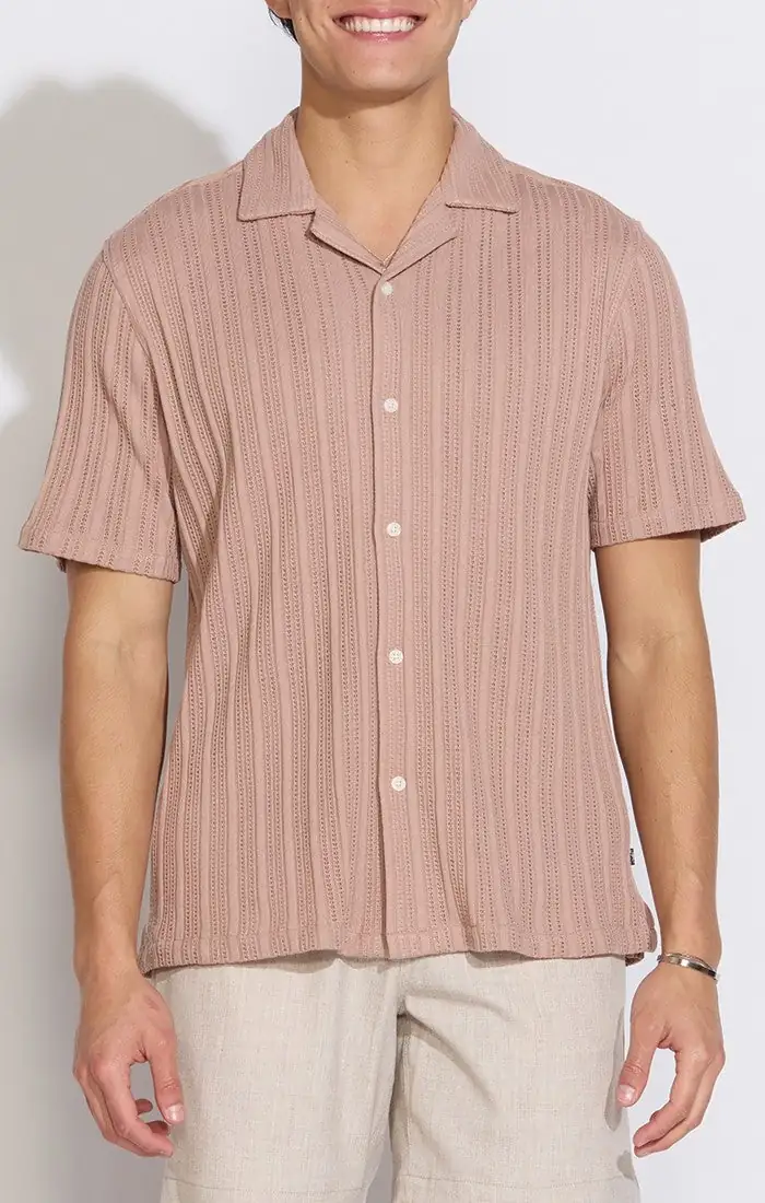 Model wearing a dusty pink pinstripe camp shirt