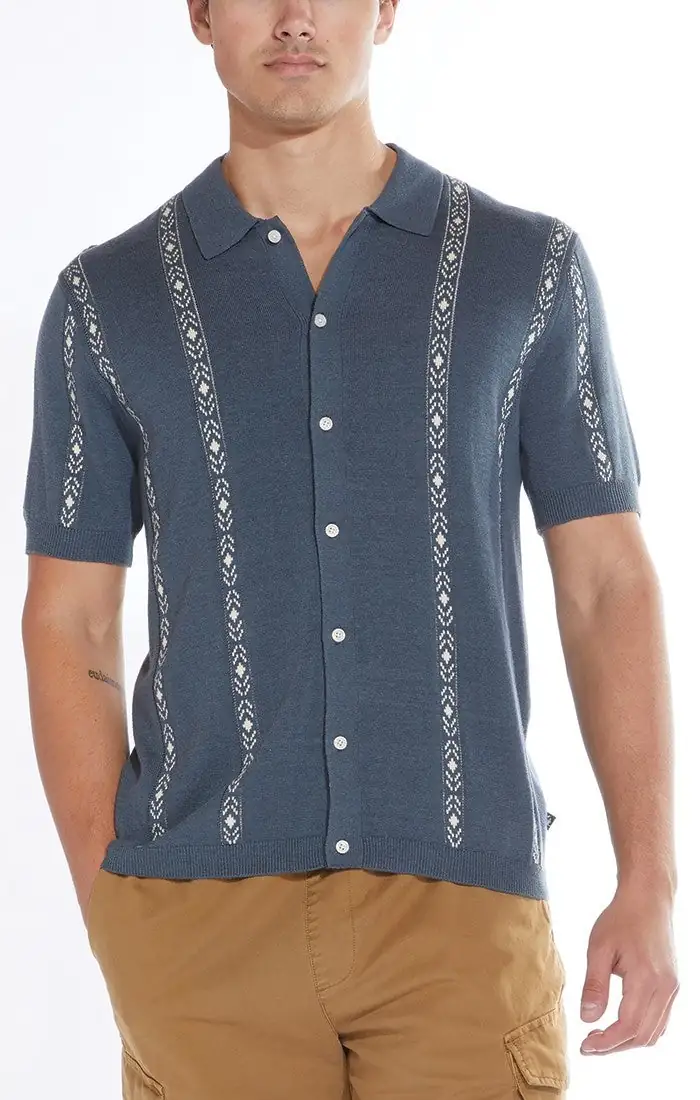Model wearing a blue patterned knit camp shirt
